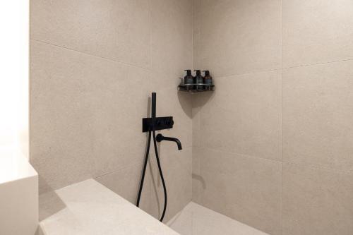 a bathroom with a shower with a hose at Cave Ryokan Hotel by Aank Sungshin Women's University in Seoul