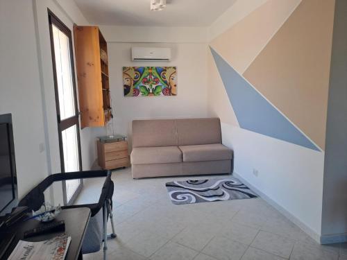 a living room with a couch and a table at Villa House of William in Lascari