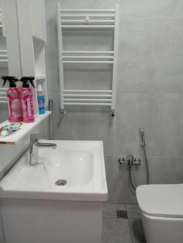 a bathroom with a white sink and a toilet at L10D10- Jasmin Travel in Sumqayyt