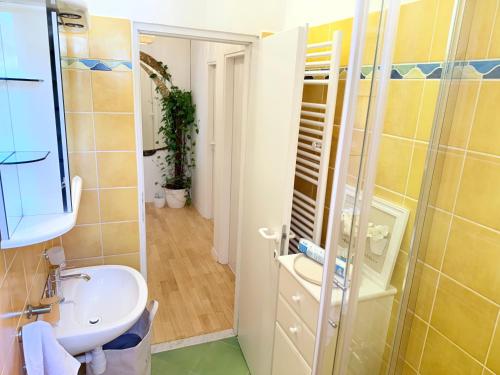 a bathroom with a sink and a shower at Luna Serene Garden Home - Jacuzzi & Gym in Zadar