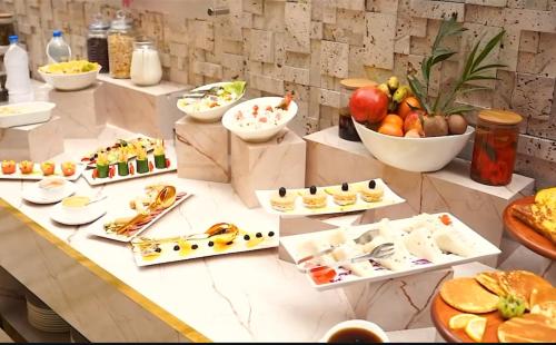 a buffet with many different types of food on a table at Villa Vista in Islamabad