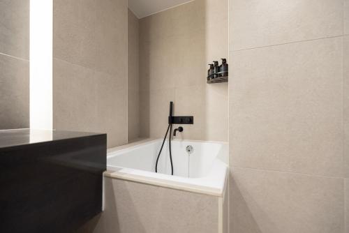 a bathroom with a bath tub in a room at Cave Ryokan Hotel by Aank Sungshin Women's University in Seoul