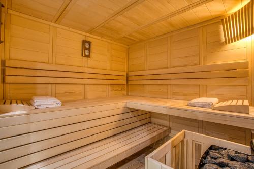 a sauna with wooden paneled walls and wooden floors at Domaine de Monrecour - Hôtel & Restaurant - Proche de Sarlat in Saint-Vincent-de-Cosse