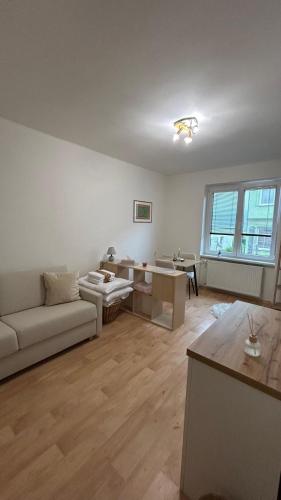 a living room with a couch and a table at Bílý klid nově zrekonstruované studio in Děčín