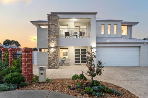a large white house with a garage at Spacious Stay near Karrinyup in Perth