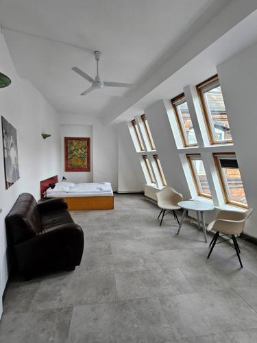 a living room with a bed and a couch at Die Fabrik - Hostel in Berlin