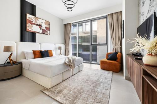 a bedroom with a white bed and a large window at 2BR plus Maid CF7 B Stylish Stay with Large Balcony in Dubai