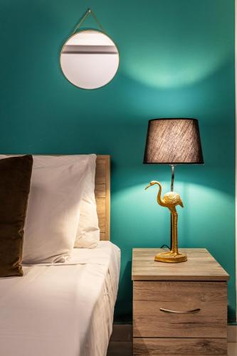 a bedroom with a bed and a lamp on a night stand at Apartment with yard and bbq - By Solea Holiday in San Ġwann