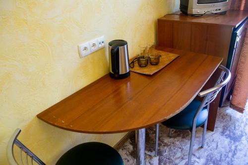 a wooden table with a coffee maker on top of it at Славна Кача in Odesa