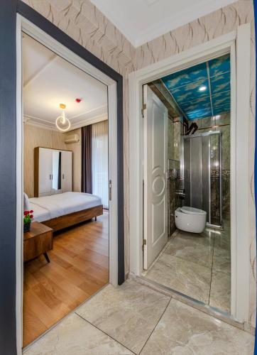 a bathroom with a glass door leading to a bedroom at Istanbul Galata Port Modern Suite & Apartments Taksim in Istanbul