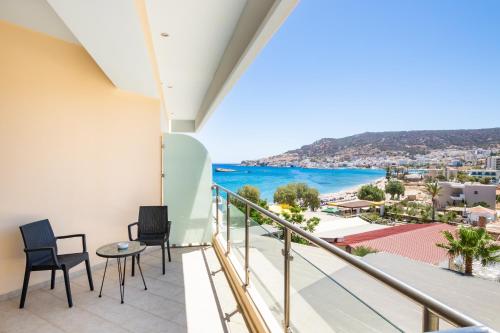 a balcony with chairs and a view of the ocean at Konstantinos Palace in Karpathos Town