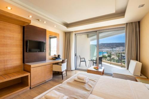 a bedroom with a large bed and a large window at Konstantinos Palace in Karpathos Town