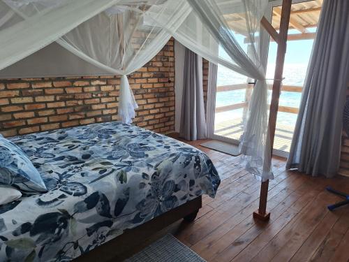 a bedroom with a bed with a blue and white comforter at Bama Breeze Beach Villas in Miramar
