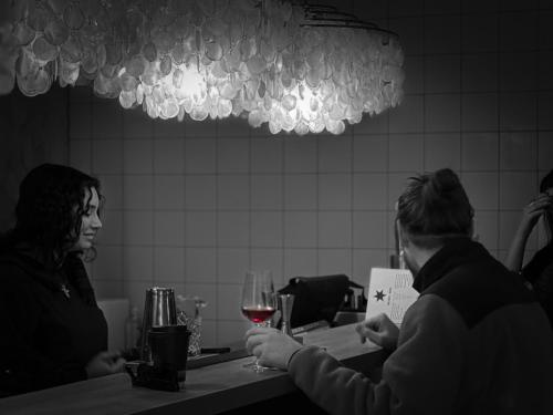 two people sitting at a table with a glass of wine at Hipsters Hotel in Thessaloniki