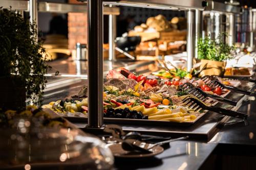 a buffet line with many different types of food at Forest Park Resort & SPA in Świeradów-Zdrój