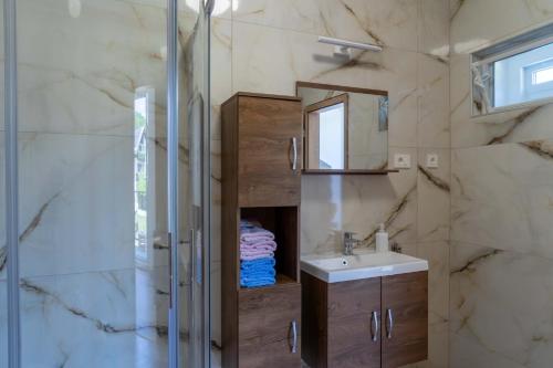a bathroom with a sink and a shower at Apartments Ema in Podčetrtek