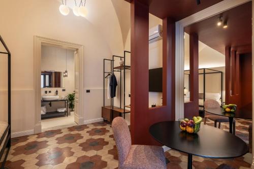 a living room with a table and chairs at Carmela Homes & Residences in Catania