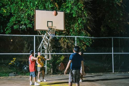 a group of people playing basketball on a court at Vista Venice Resort in Morong