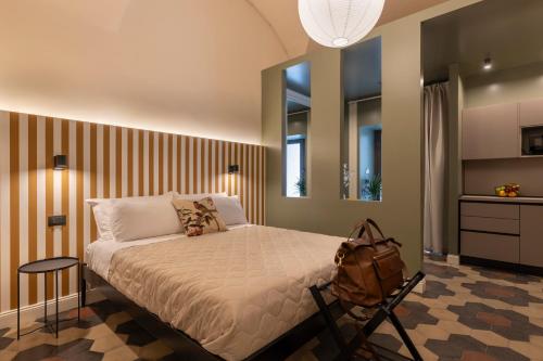 a bedroom with a bed with a backpack on it at Carmela Homes & Residences in Catania