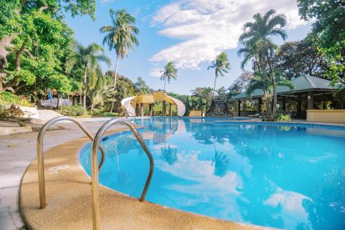 a swimming pool with a slide in a resort at Vista Venice Resort in Morong