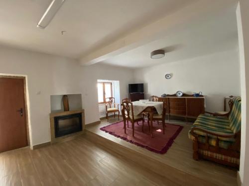 a living room with a table and a fireplace at Casa Museu da Avó Gena in Mazouco