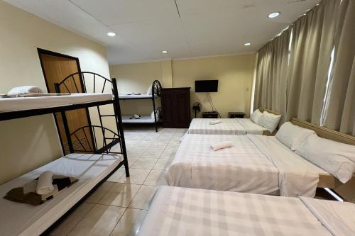 a room with two bunk beds and a television at Vista Venice Resort in Morong