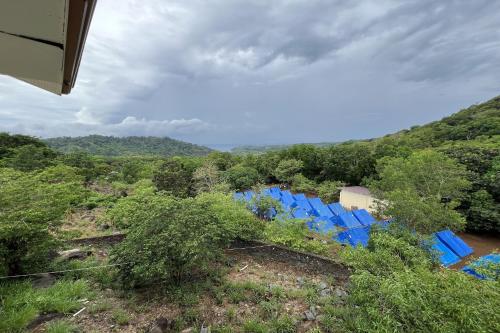 a group of blue chairs sitting on a hill at Vista Venice Resort in Morong