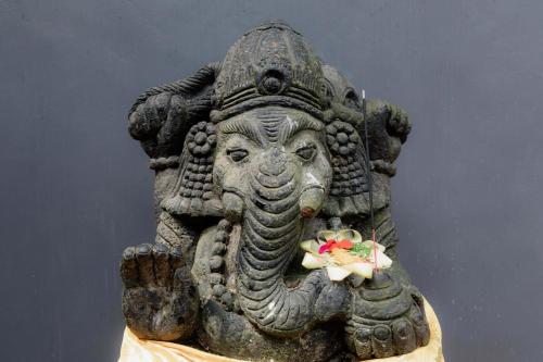 a statue of an elephant holding a flower in its mouth at Uma Nandhi Villa Ubud in Tegalalang