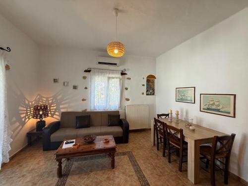 a living room with a couch and a table at Atlazia Suites in Alinda