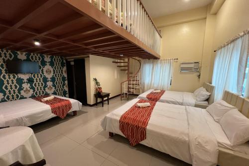 a hotel room with two beds and a staircase at Vista Venice Resort in Morong