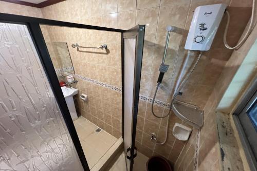 a shower with a glass door in a bathroom at Vista Venice Resort in Morong