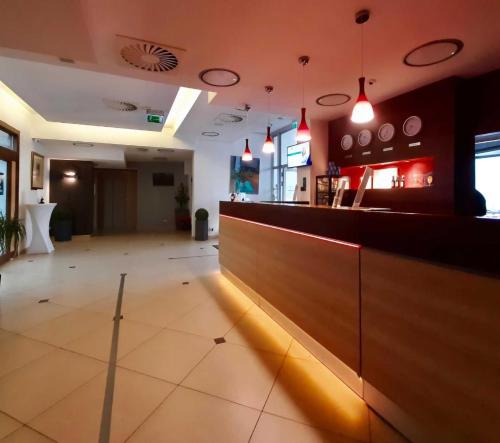 a restaurant with a bar with lights on it at Poleczki Residence Apartments in Warsaw