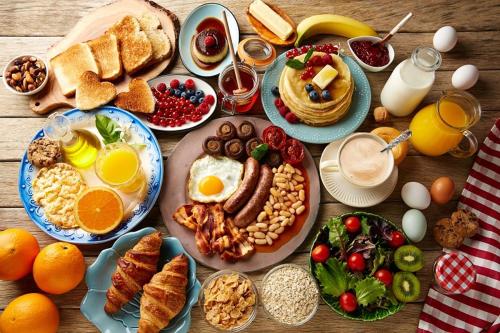 a table full of breakfast food with eggs and bread at Penzión Svätopluk v Korytnici in Liptovská Osada