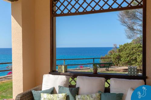 a living room with a view of the ocean at Villa Anna - Charming dimora suspended over the sea in Geremèas