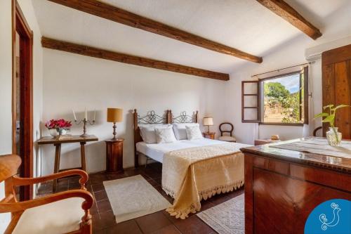 a bedroom with a bed and a window at Villa Anna - Charming dimora suspended over the sea in Geremèas
