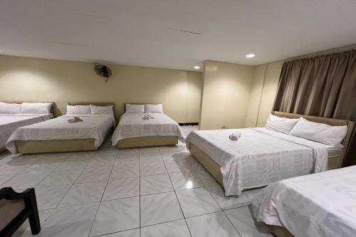 a hotel room with two beds with white sheets at Vista Venice Resort in Morong