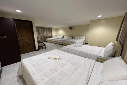 a hotel room with two beds with white sheets at Vista Venice Resort in Morong