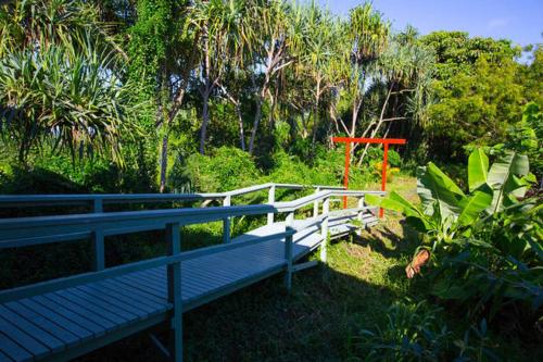 a blue bench sitting next to a white fence at Kirpal Meditation and Ecological Center in Pahoa