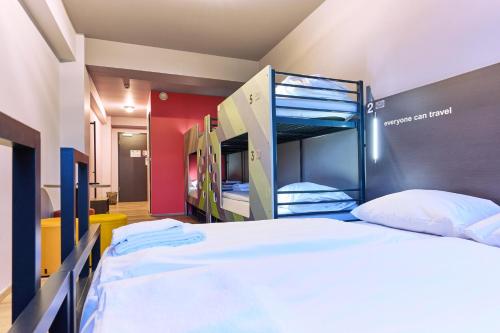 a bedroom with two bunk beds in a room at a&o Bremen Hauptbahnhof in Bremen