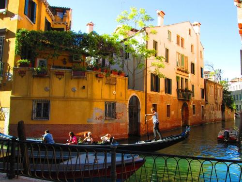 a group of people riding a gondola down a canal at Hotel Riviera dei Dogi in Mira