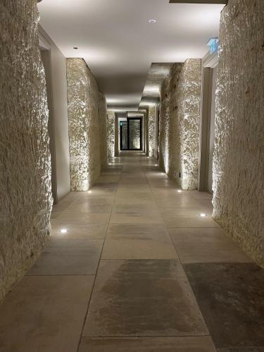 a hallway of a building with stone walls at Château de Perreux, The Originals Collection in Amboise
