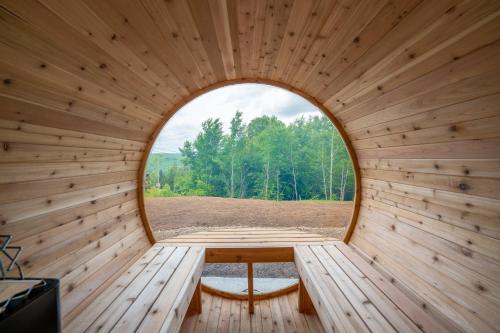 an inside view of a sauna with a round window at Chalet Le Lea - Spa & Sauna in Saint Come