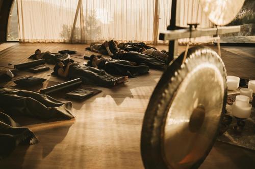 a group of people laying on the floor in a room at Acro Suites - A Wellbeing Resort in Agia Pelagia
