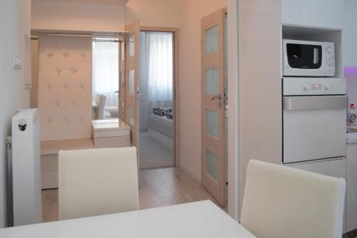 a kitchen with a table and chairs and a microwave at Sofia Apartment in Budapest
