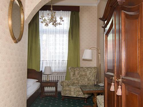 a hotel room with a bed and a chair and a window at Hotel Stephan in Hamburg