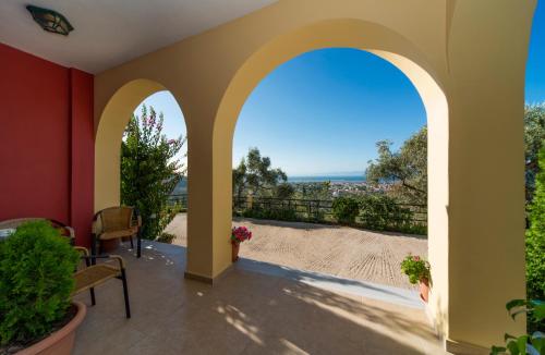 a patio with an archway and a view of the beach at Irida in Lefkada Town