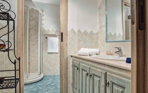 a bathroom with a sink and a shower at Sea View Grande Pevero 5 in Porto Cervo