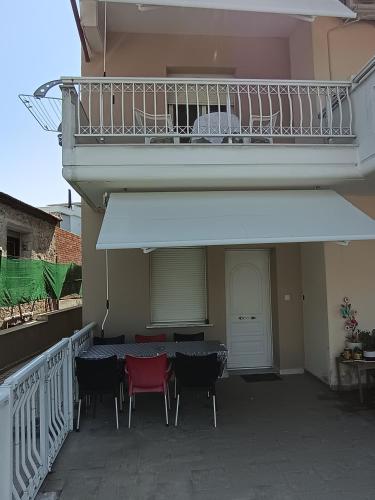 a balcony with a table and chairs on a patio at Chéz Vasŏ ** leisure maisonette** in Kassandria