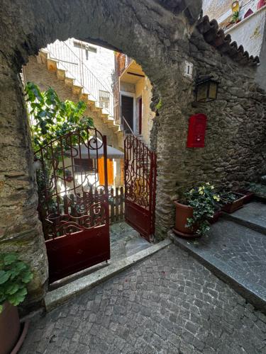 an entrance to a stone building with an open gate at Appartamento in Centro Storico in Dorio