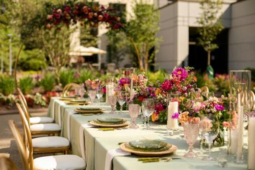 a long table with plates and glasses and flowers at Pittsburgh Airport Marriott in Robinson Township